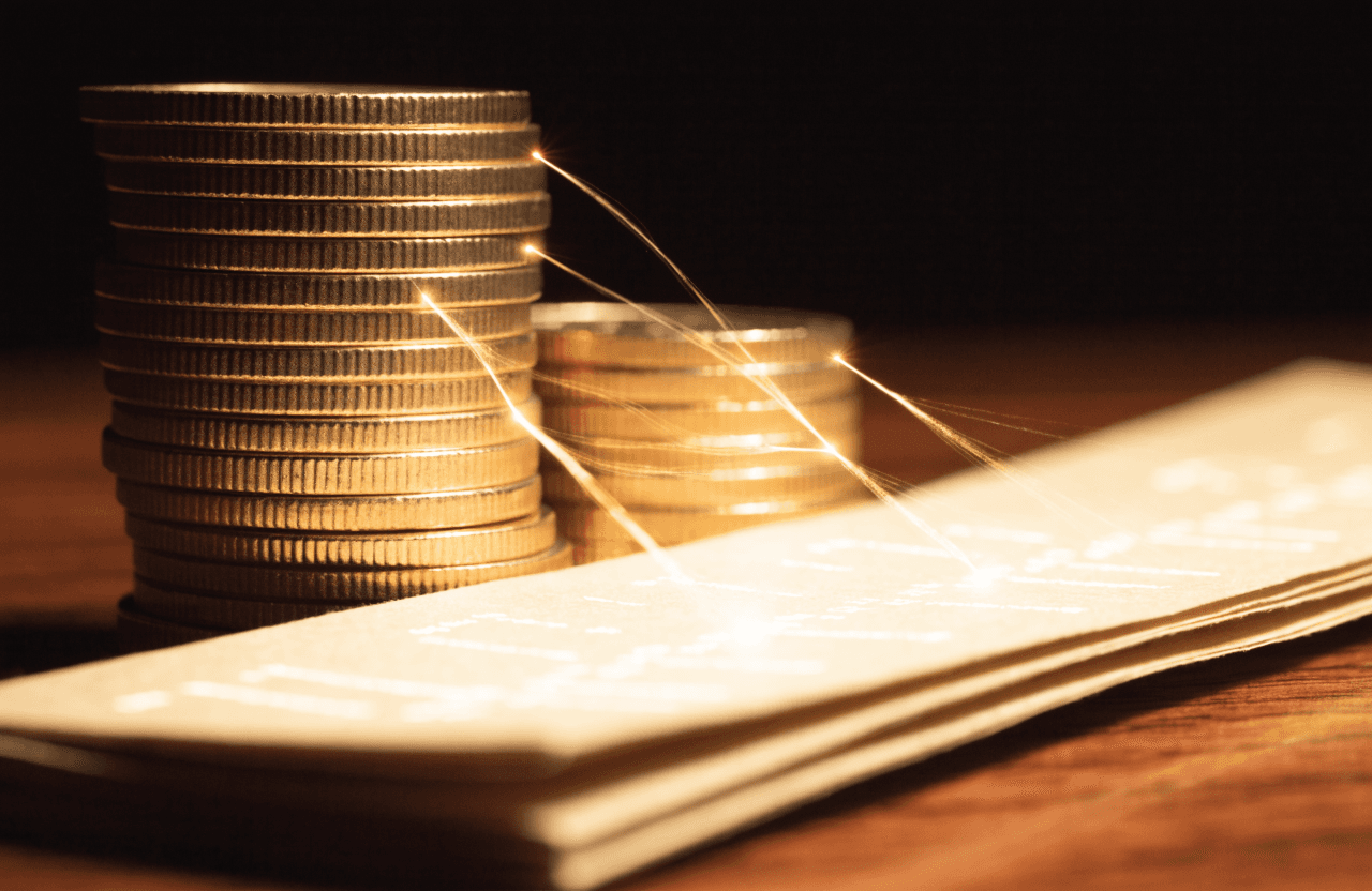 Coins and a bank statement joined by threads of light matching entries together.